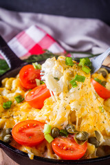 delicious pasta and cheese casserole in a cast iron skillet