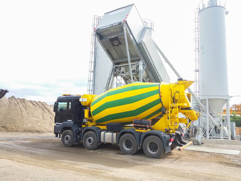 Concrete mixer truck in front of a concrete batching plant, cement factory