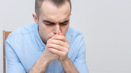Religious person prays sitting down, portrait, closeup, copy space, 16:9