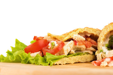 Pancake made from oatmeal, oiled with yogurt and stuffed with chicken fillet, lettuce and tomato.