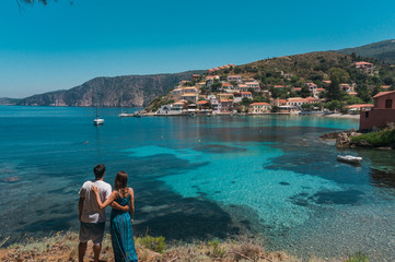 young couple on the beach in the village of Assos. Kefalonia Island, Greece