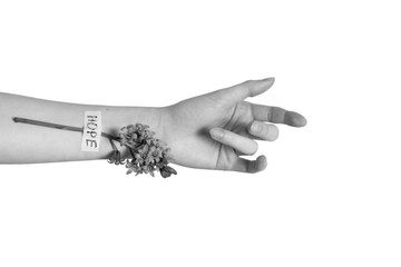 black and white photo, female hand and a flower is glued on her vein