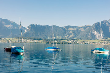Fototapeta na wymiar lake with yachts and mountains landscape