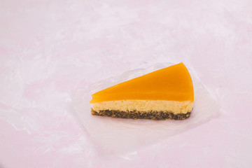 Piece of cheesecake with sea buckthorn and cake