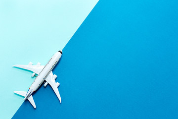Miniature toy plane is traveling the world theme on blue background. Travel concept