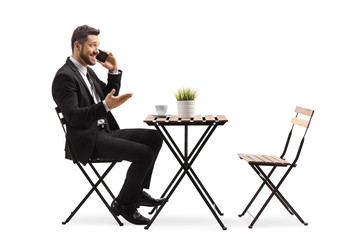 Businessman in a cafe talking on a mobile phone