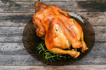 Baked chicken on wooden background