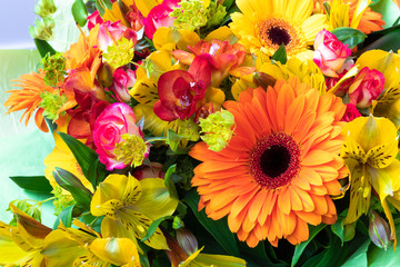 Bright orange gerbera in a bouquet of flowers. Beautiful bouquet gift for the holiday. Flowering plants as a postcard.