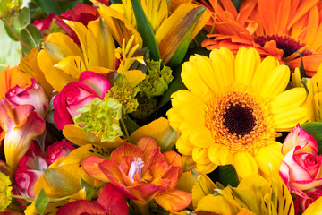 Bright yellow gerbera in a bouquet of flowers. Beautiful bouquet gift for the holiday. Flowering plants as a postcard.