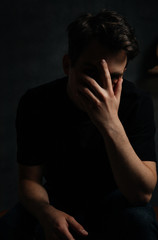 young and handsome man in studio lighting shows emotions