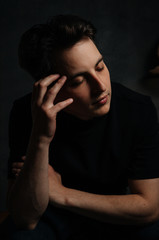 young and handsome man in studio lighting shows emotions