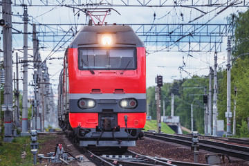 Obraz premium Passenger train approaches to the station at evening time..