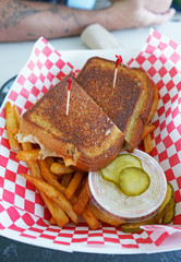 Toasted sandwich on a plate with french fries. 