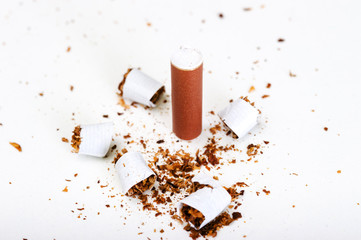 Cut cigarette with a brown filter isolated on a white background, Smoking cessation.
