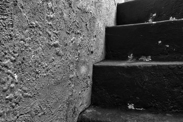Old historic dungeon or basement stairs, abandoned stairs close-up background black and white