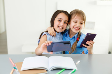 Fototapeta na wymiar two little girls studying online. Distance Learning Online, e-learning, concept