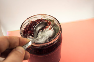 Colonies of microorganisms. Mold on jam. Macro shot. Water drop on gray, yellow mold. Mold drinks...