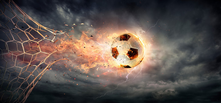 Goal - Fiery Soccer Ball breaking Through The Net With Dramatic Sky
