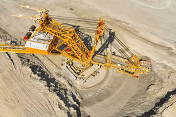 Top view of a bucket wheel excavator mining coal in an open pit mine. 