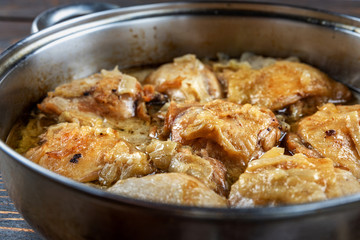 Chicken thighs fried in a pan, close-up, shallow depth of field, selective focus. Homemade food concept.