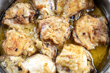 Fried chicken thighs in a pan, appetizing, tasty. close-up, shallow depth of field. Homemade food concept.
