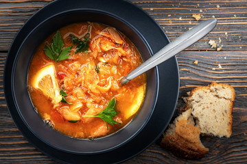 Red soup with vegetables and meat, tasty, appetizing traditional Ukrainian borsch, close-up, top view, shallow depth of field, selective focus. Healthy Home Food Concept