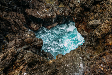 Part of the ocean surrounded by rocks. Volcanic rocks on the island of Tenerife