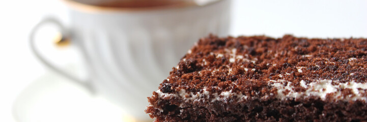 Banner. Homemade chocolate brownies with cup of tea on white background, selective focus
