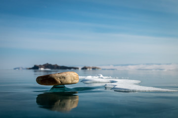 A small stone on the ice of Lake Baikal