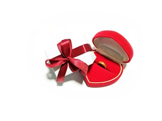 wedding gold ring in a love box and gift box with a red ribbon