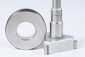 Mechanical Three-Point Internal Micrometer with Setting Ring on a white background.