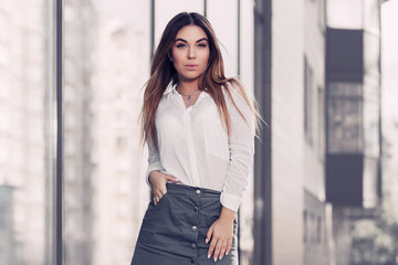 Young fashion woman in white shirt and gray skirt