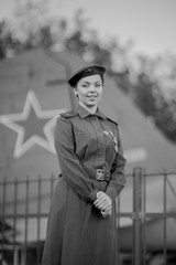 Retro style black and white photography. A young female pilot in uniform of Soviet Army pilots...