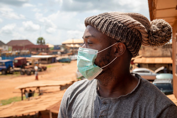 african man wearing a face mask outside