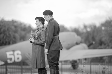 Retro style black and white photography. Young adult man and woman in the Military uniform of...
