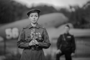 Retro style black and white photography. Young adult man and woman in the Military uniform of...