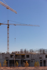Industrial workers and builders with hardhat in uniform pour concrete and mount reinforcesment carcass at construction site