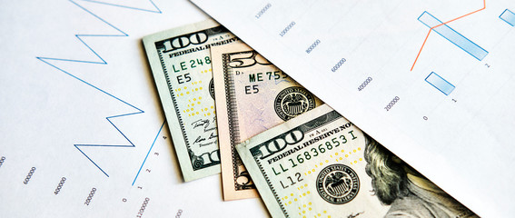Economic charts of growth and financial crisis with banknotes
