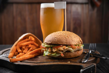 American hamburger with crab and french fries meat on wooden board