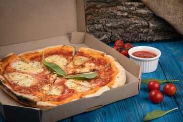Food delivery. Margarita pizza on wooden board 
