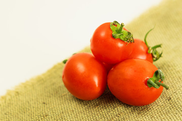Ripe cherry tomatoes folded on a cloth