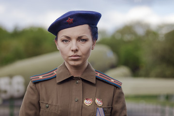 A young female pilot in uniform of Soviet Army pilots during the World War II. Military shirt with...
