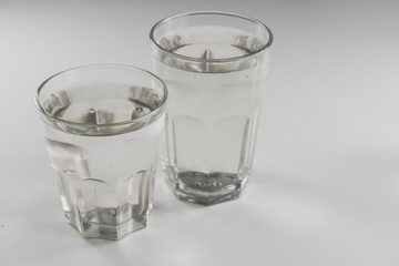 Two glasses of clean water on a white table