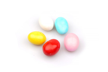 Group of delicious colorful chocolate dragees on white background