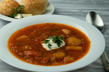 Ukrainian borsch with donuts and sour cream.