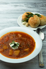 Ukrainian borscht with donuts and sour cream.