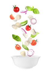 Mozzarella cheese, tomatoes, onion and basil leaves falling into bowl on white background