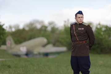 A young adult male pilot in the uniform of pilots of the Soviet Army of the World War II period....