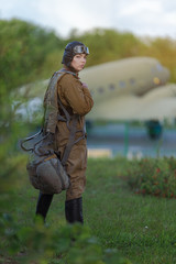 A young female pilot in uniform of Soviet Army pilots during the World War II. Military shirt with...