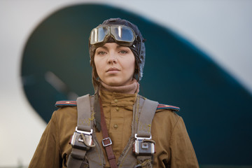 A young female pilot in uniform of Soviet Army pilots during the World War II. Military shirt with...